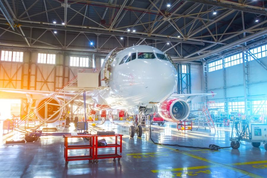 Airliner under maintenance in a bright hangar